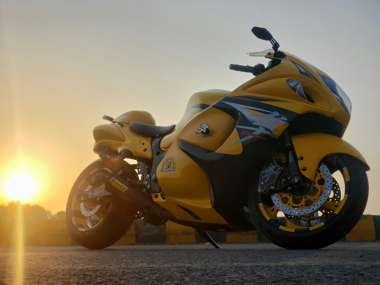 yellow and black sports bike on brown sand during sunset, sports bike